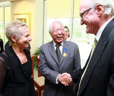 The Australian High Commissioner to Malaysia, H. E. Mr Miles Kupa (right) congratulating Mr Hijjas Kasturi (centre) after receiving the honorary award.  Looking on is the latter's wife, Mrs Angela Hijjas.